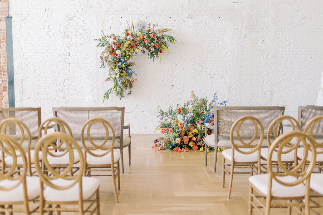 Vibrant flowers on the wall in front of chairs ready for a Tampa, FL hotel wedding