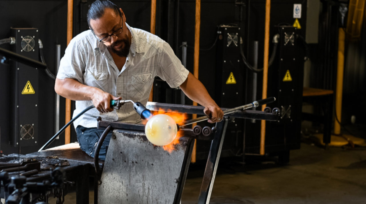 Man heating up blown glass at our Ybor City, Florida hotel