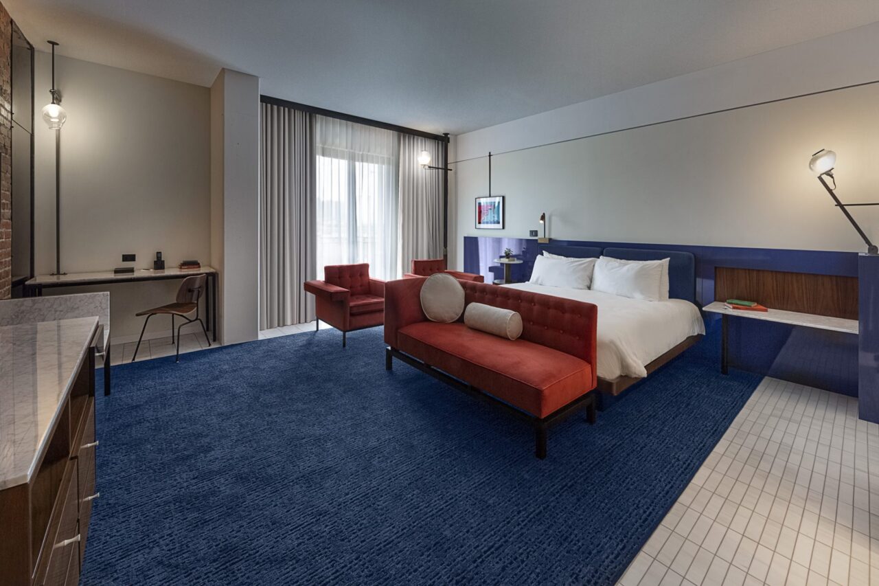 Spacious Tampa boutique hotel room decorated in red and blue