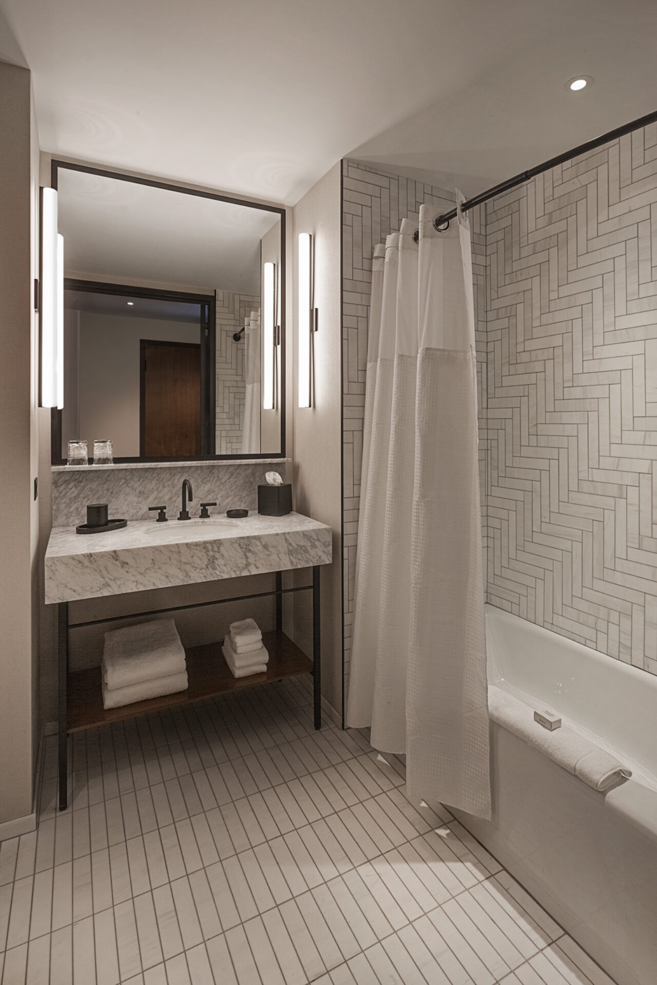 Modern bathroom with a large mirror at our Ybor City, Tampa hotel