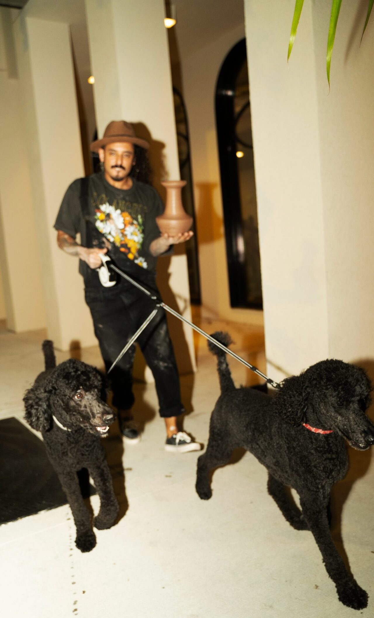 Male walking with his two Black dogs at our pet friendly hotel in Tampa