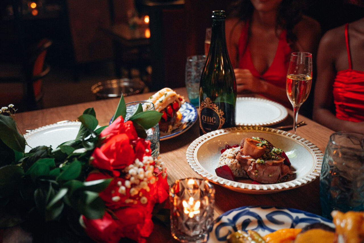 Roses and champagne on a dinner table at our boutique hotel in Tampa